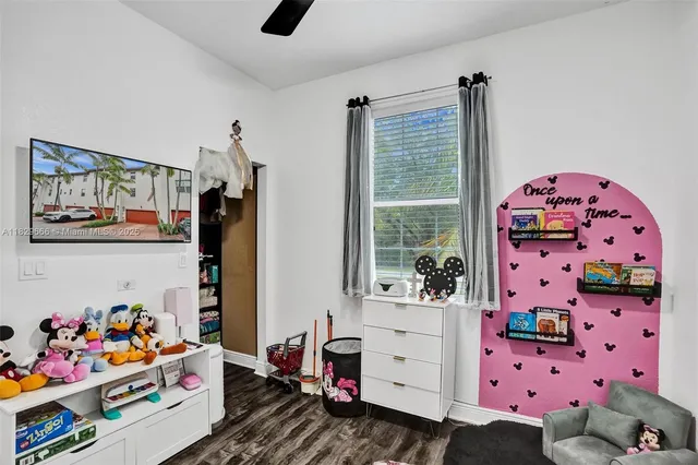 a bedroom with furniture and a book shelf