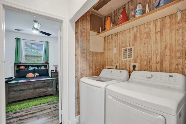 a bedroom with furniture and a flat screen tv