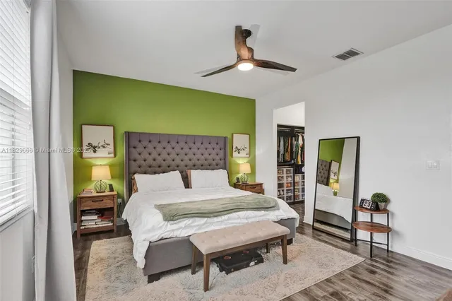 a bed sitting in a bedroom next to a window