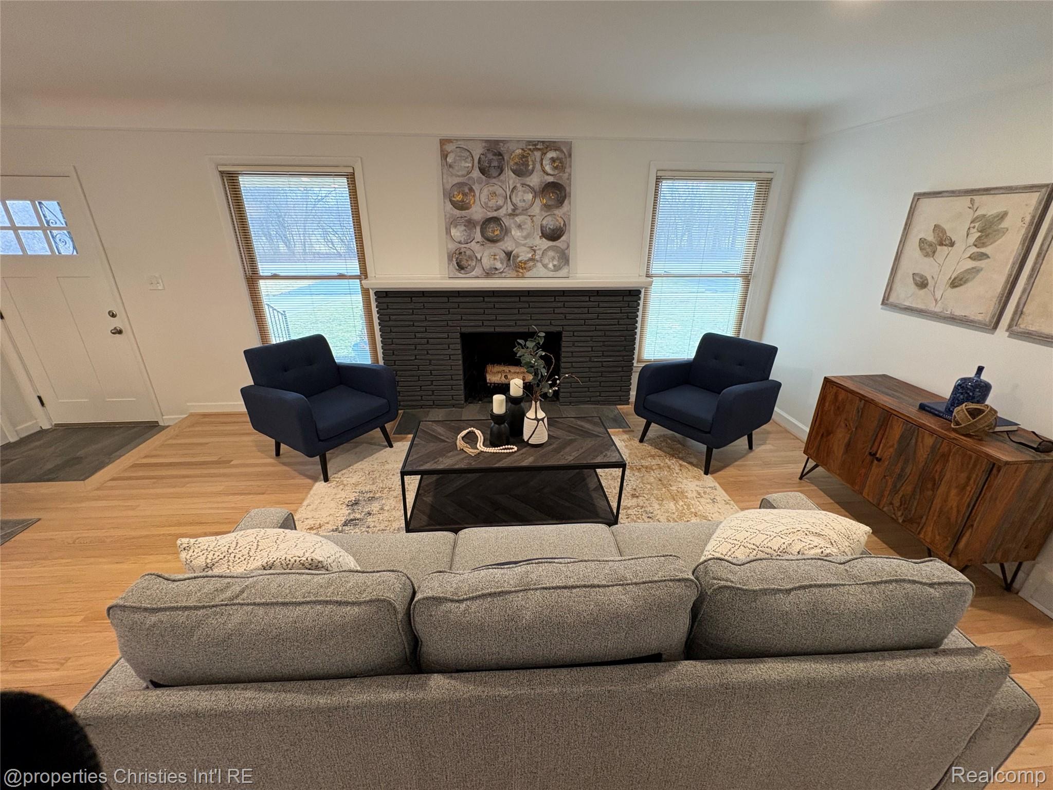 17330 Beverly Road Franklin, MI 48025 - Photo 3 of 24 Living area with light wood finished floors and a brick fireplace