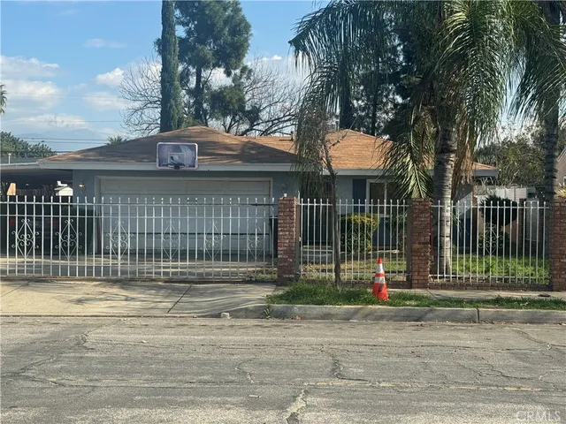 a front view of a house with a garden and plants
