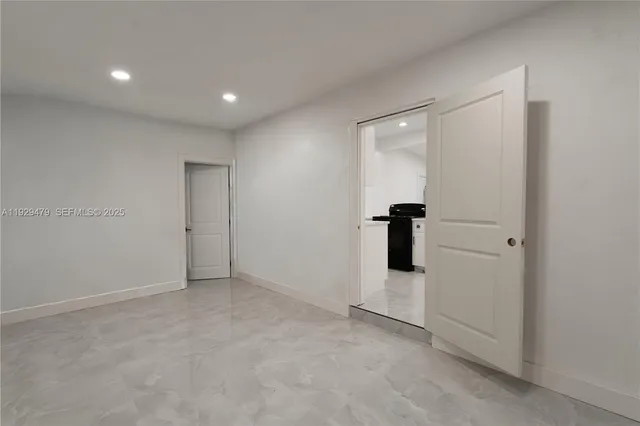 an empty room with closet and mirror