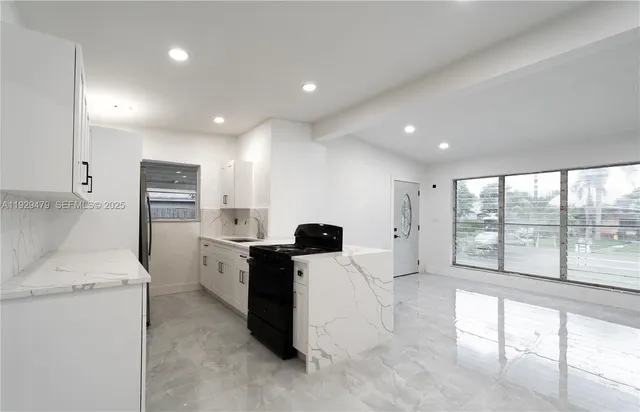 a kitchen with stainless steel appliances a refrigerator and a stove top oven