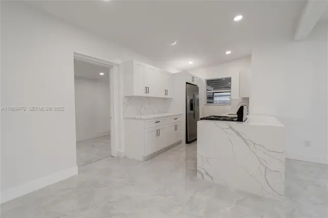 a room with a refrigerator and a sink