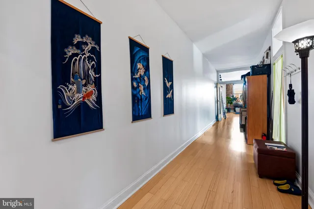 a view of a hallway with wooden floor