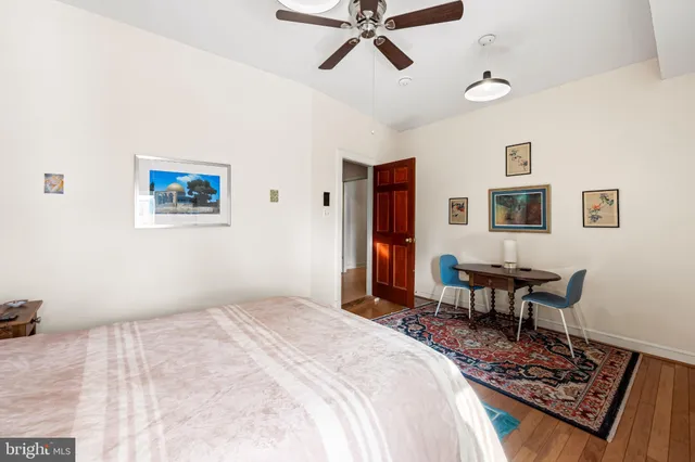 a bedroom with a bed a desk and chair