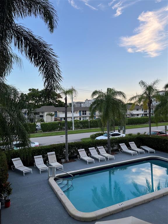 44 Southeast 14th Street, Unit 104 Boca Raton, FL 33432 - Photo 13 of 21 a view of a swimming pool and lounge chairs in patio