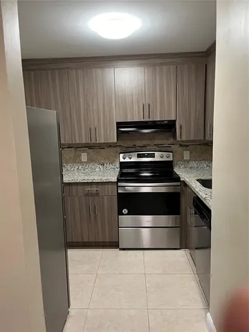 a kitchen with a stove and a refrigerator