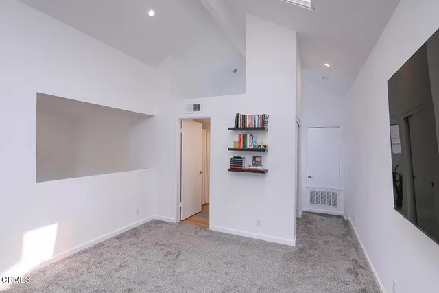 a view of kitchen and refrigerator