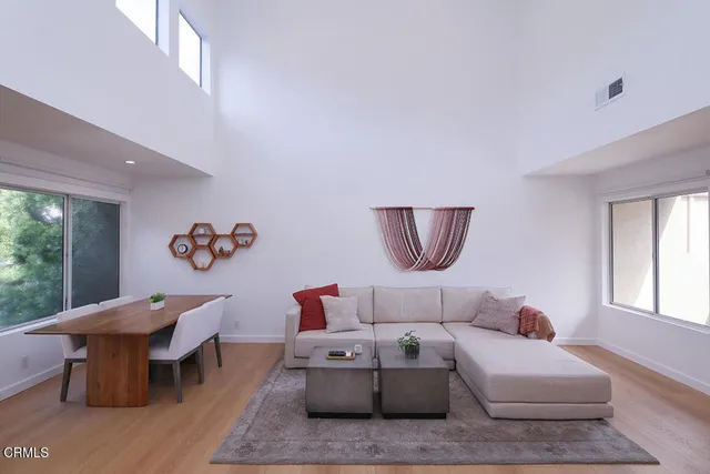 a living room with furniture a rug and a table