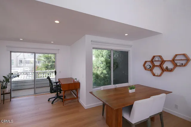 a view of a dining room with furniture window and wooden floor
