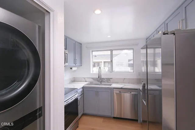 a kitchen with a sink a washer and dryer