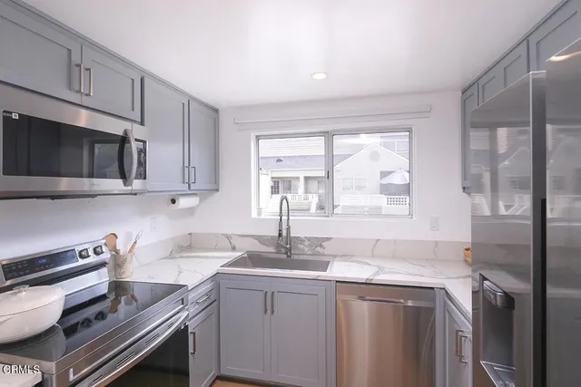 a kitchen with a sink cabinets and window