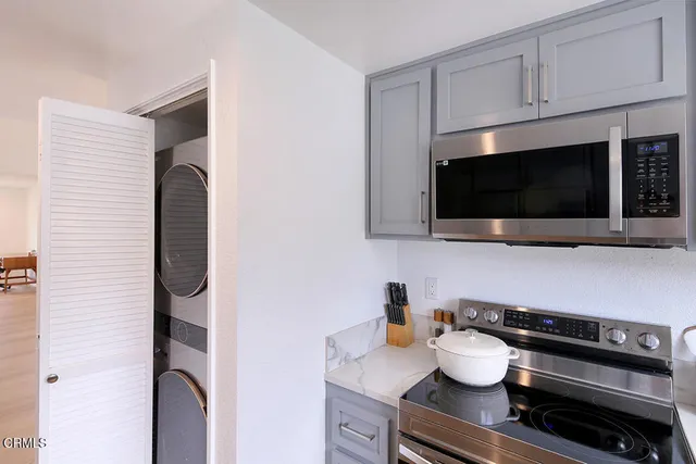 a kitchen with a microwave a stove and cabinets