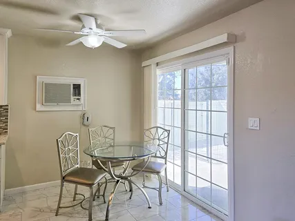 a view of a dining room with furniture a chandelier and wooden floor