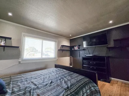a bedroom with a bed and wooden floor