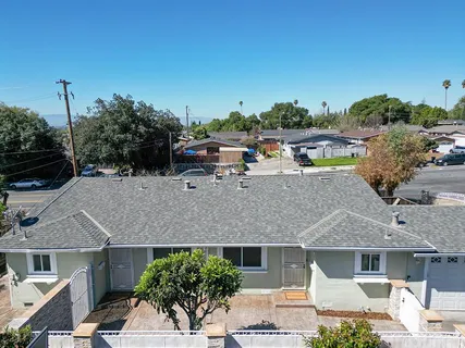 a aerial view of a house with a yard and sitting area