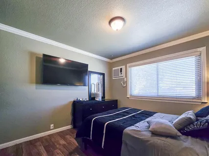 a bed room with furniture and a flat screen tv