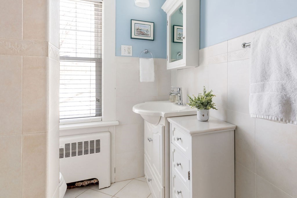 60 High Street Needham, MA 02494 - Photo 24 of 32 a bathroom with a sink and a mirror