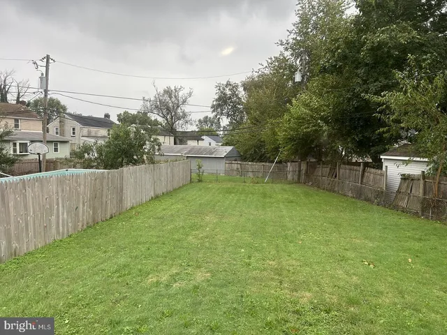 a view of a backyard with wooden fence