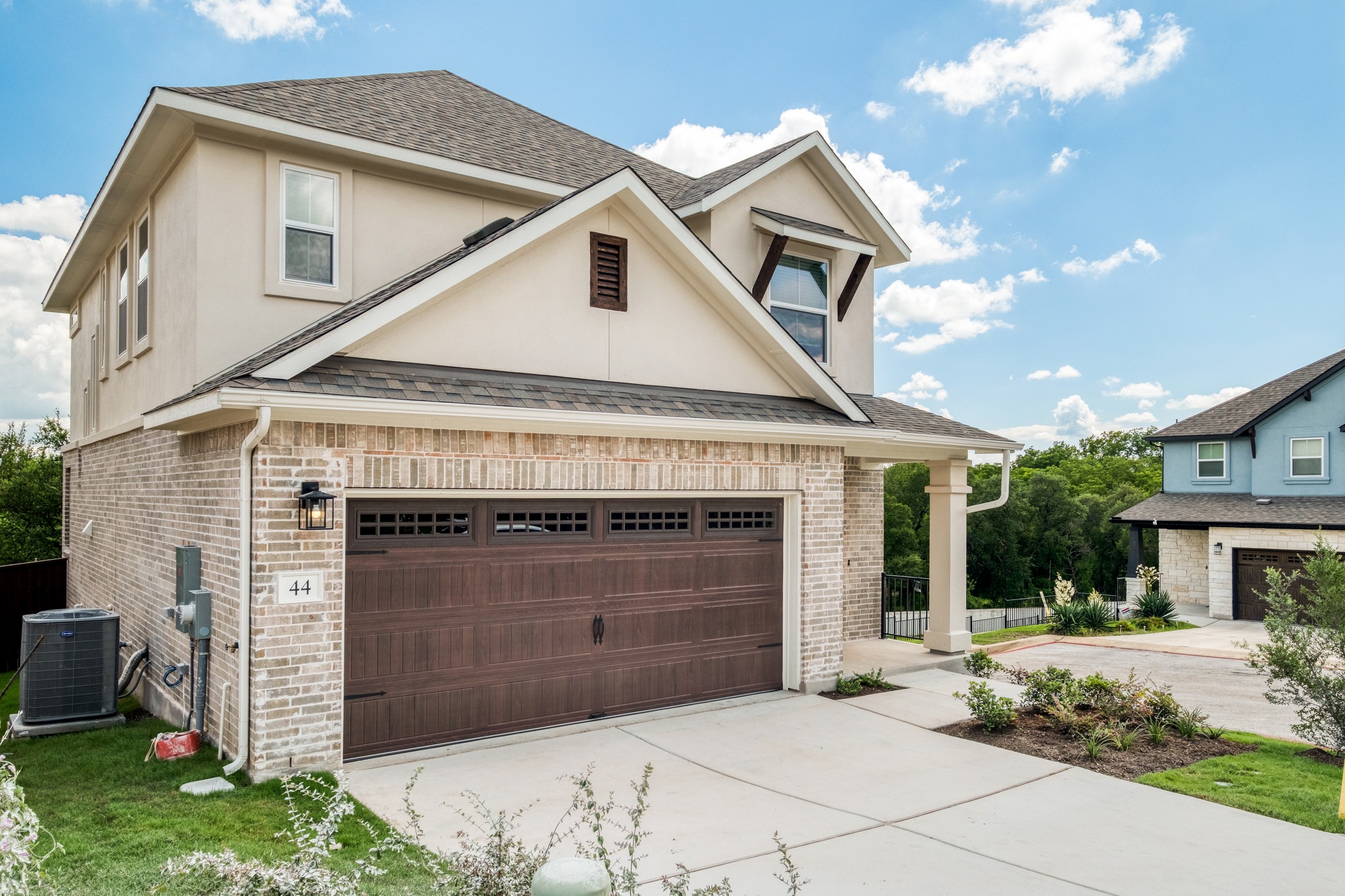 2605 Sam Bass Road, Unit 44 Round Rock, TX 78681 - Photo 3 of 26 A striking exterior presents a welcoming entryway with a durable garage and inviting landscape elements. Neighbors on one side only.