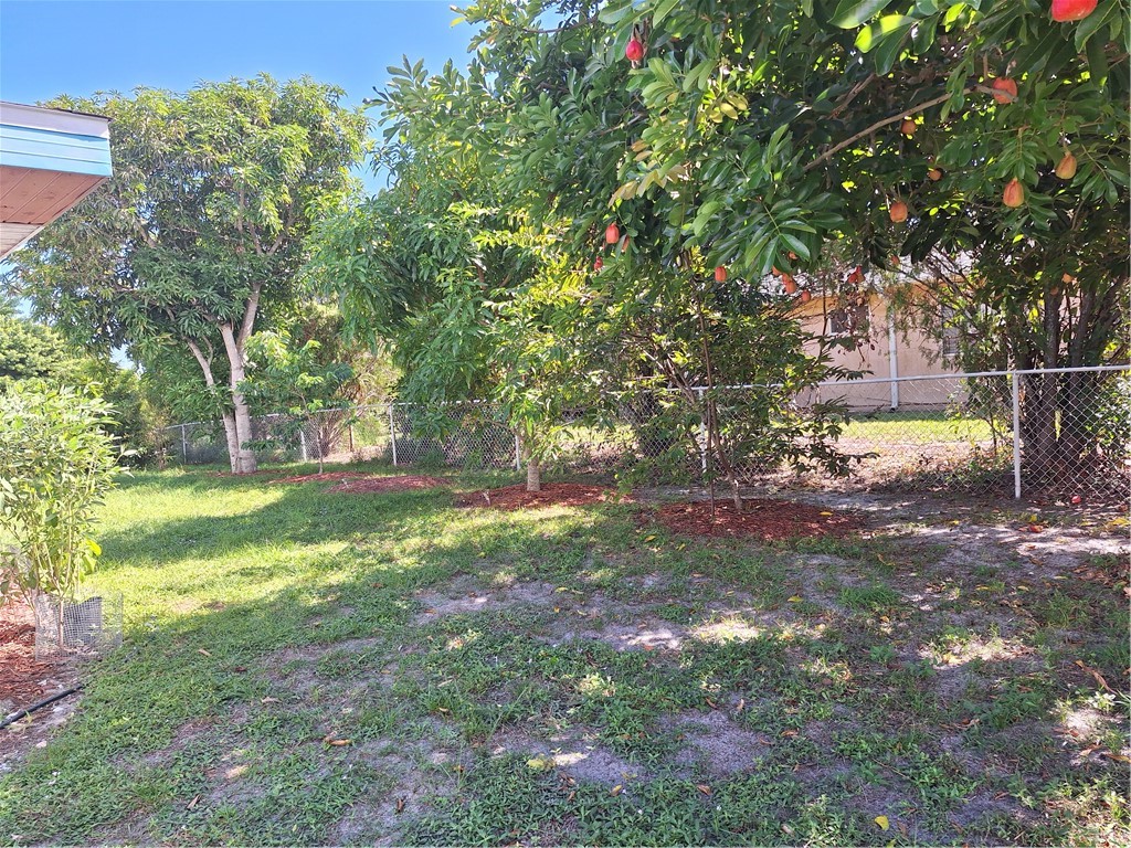 999 Laredo Lane Sebastian, FL 32958 - Photo 4 of 19 a backyard of a house with table and chairs