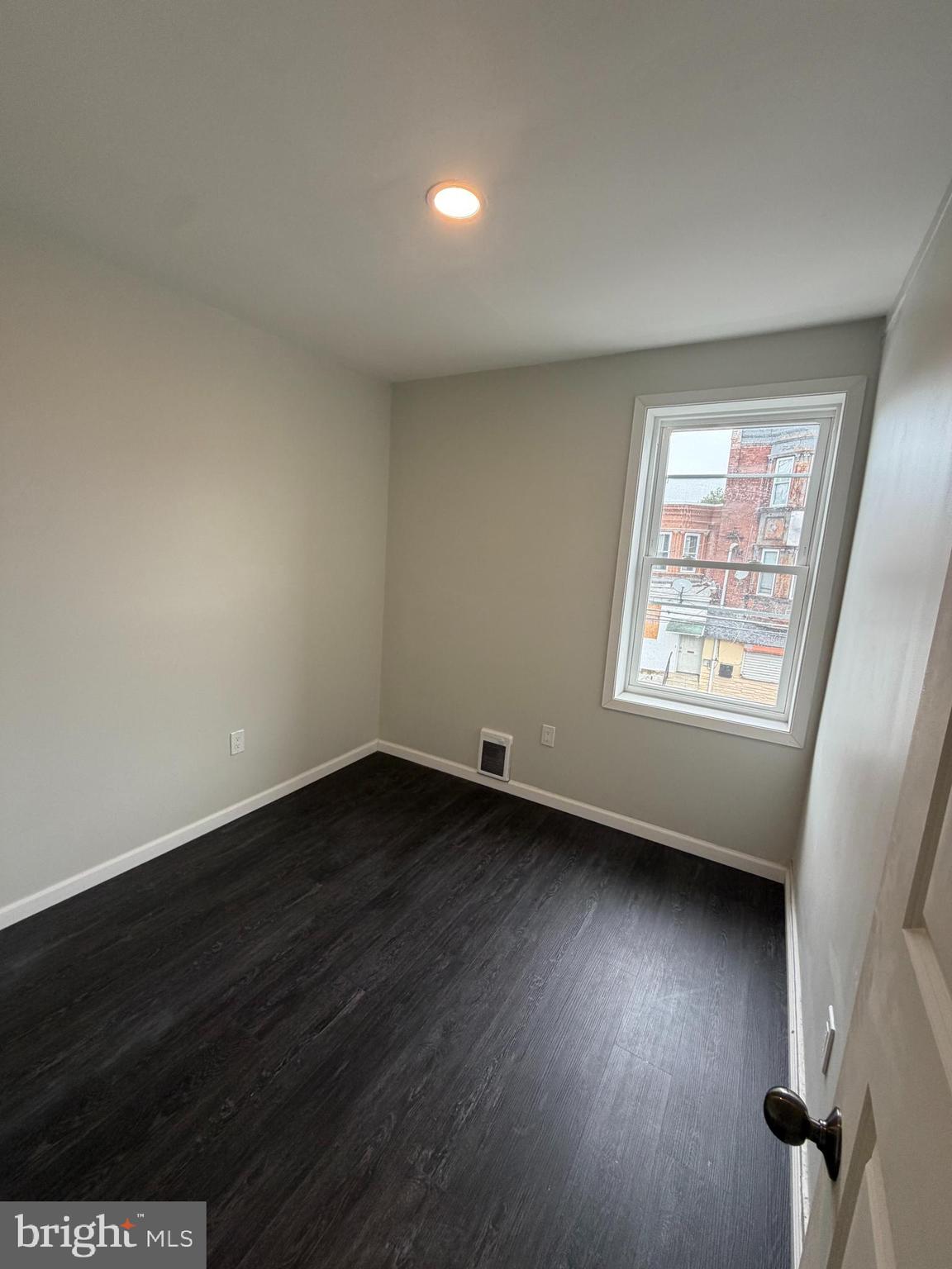 3760 North 9th Street Philadelphia, PA 19140 - Photo 8 of 17 an empty room with wooden floor and windows