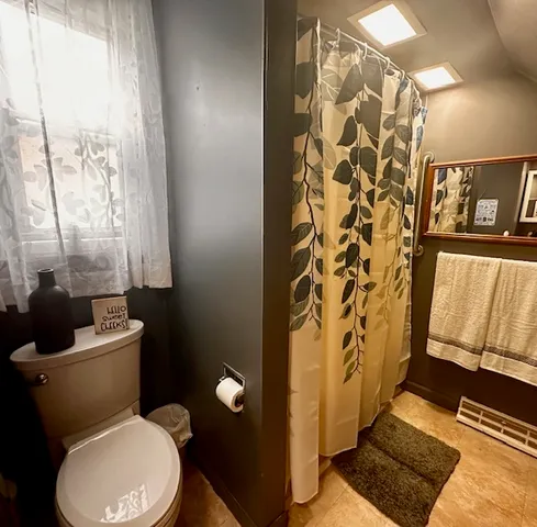 a white toilet sitting next to a bathroom sink