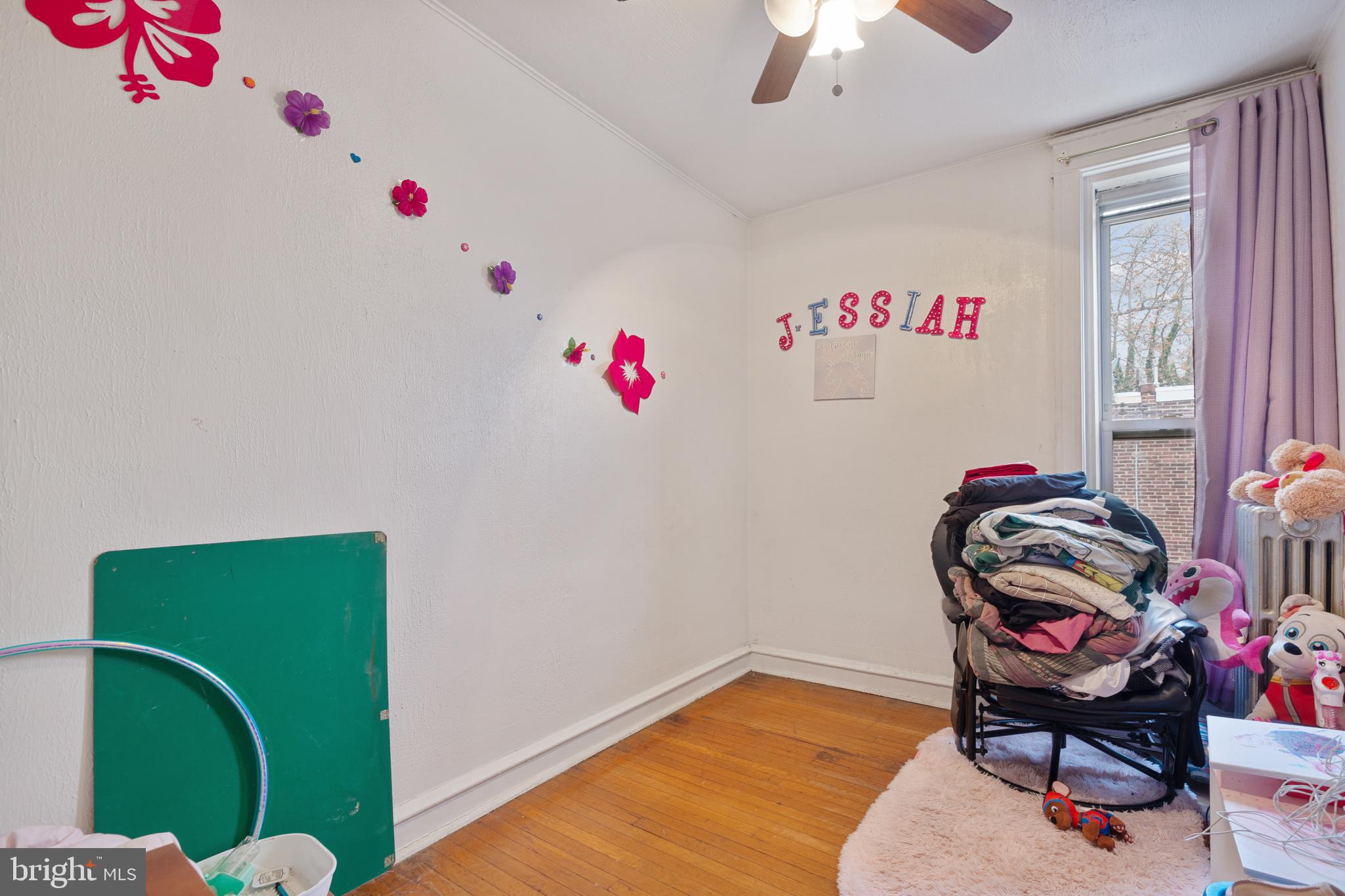414 Hampden Road Upper Darby, PA 19082 - Photo 9 of 11 a bedroom with a bed and a chandelier