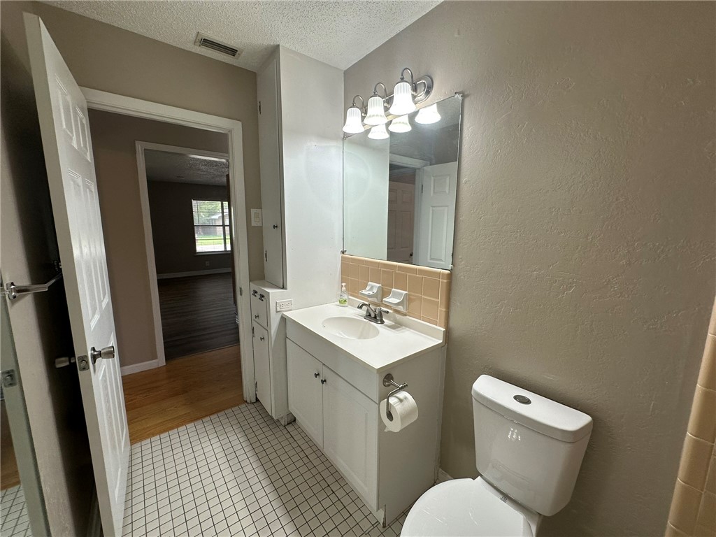 1610 Crosby Street Portland, TX 78374 - Photo 14 of 27 a bathroom with a toilet sink and mirror