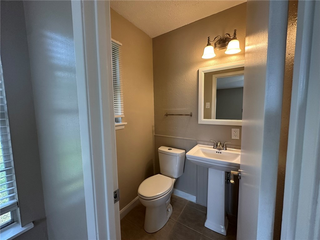 1610 Crosby Street Portland, TX 78374 - Photo 22 of 27 a bathroom with a toilet sink and mirror