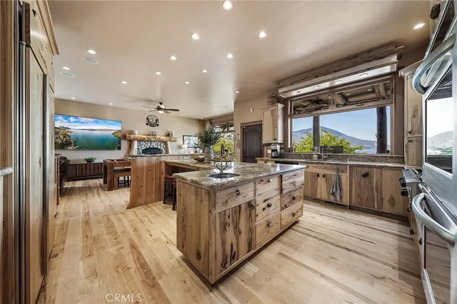 a kitchen with stainless steel appliances granite countertop a sink and a refrigerator