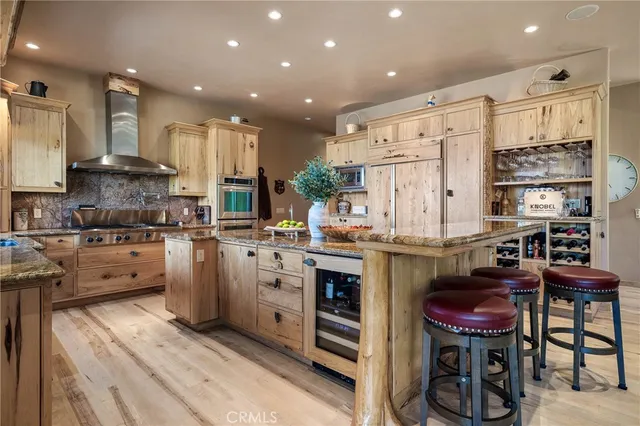 a kitchen with stainless steel appliances granite countertop a stove and a refrigerator