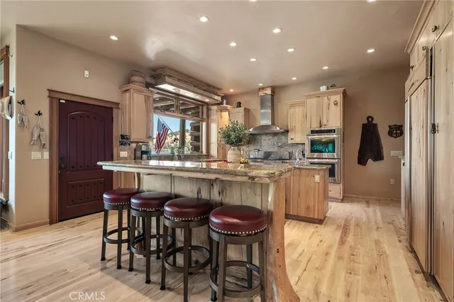 a kitchen with a stove a refrigerator and a dining table