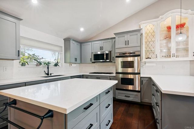 a kitchen with a stove a sink and a refrigerator