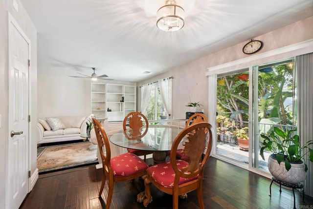 a living room with furniture a window and a ceiling fan