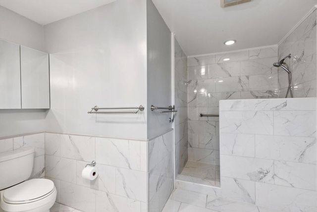 a bathroom with a toilet and a shower