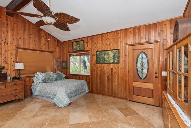 a bedroom with furniture and a window