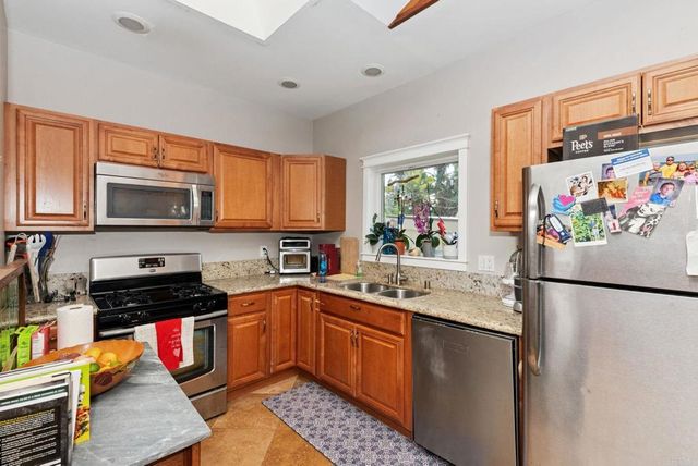 a kitchen with a sink stove and refrigerator