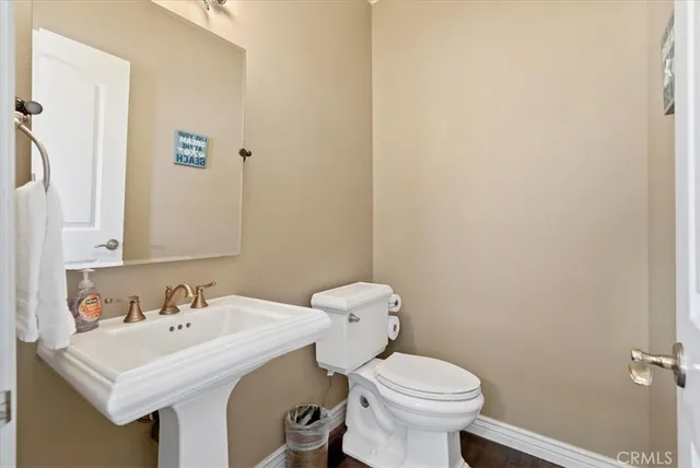 a bathroom with a sink a toilet and mirror