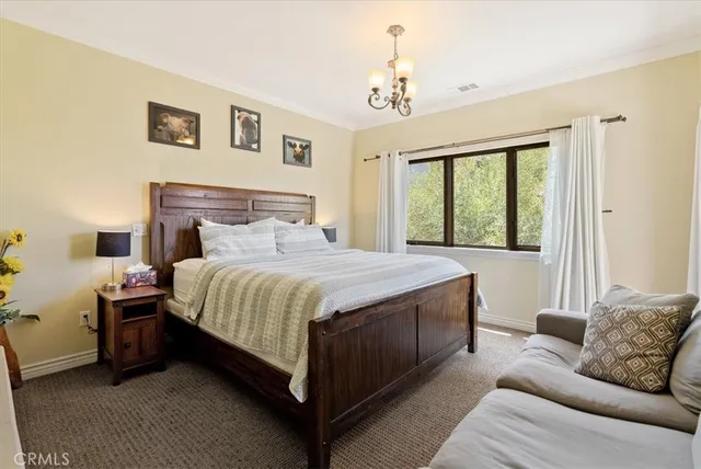 a bedroom with a bed couch and window