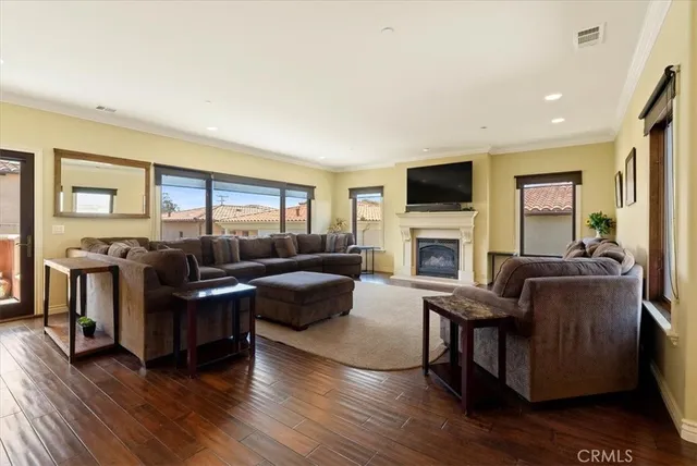 a living room with fireplace furniture and a flat screen tv