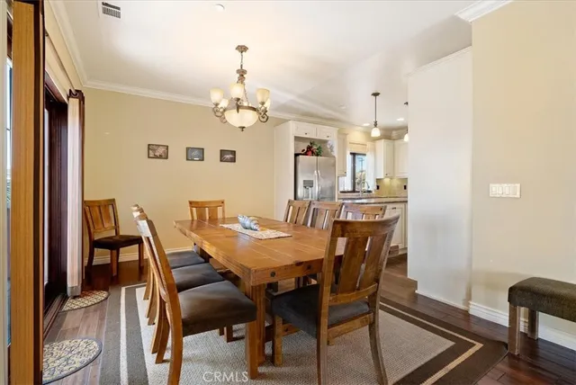 a view of a dining room with furniture and a chandelier