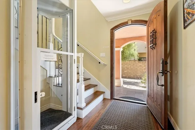 a view of an entryway with wooden floor and a livingroom view