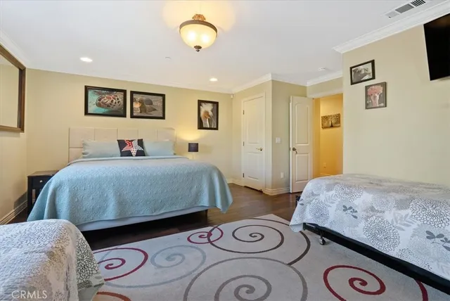 a bedroom with a bed and a tv