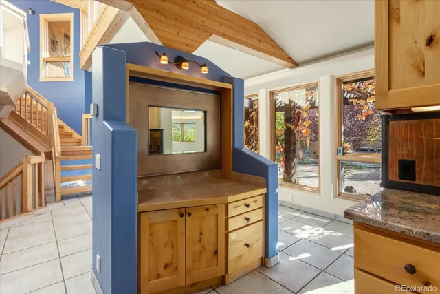 a bathroom with a granite countertop sink and a mirror