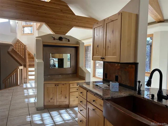 a view of a kitchen with a sink and a large window