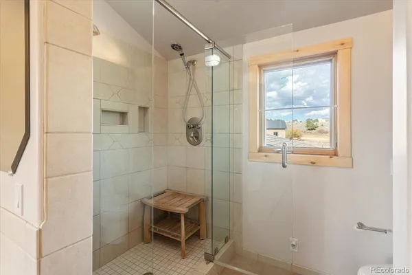 a bathroom with a window and a shower