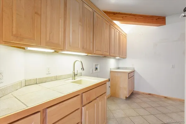 a kitchen with a sink and cabinets