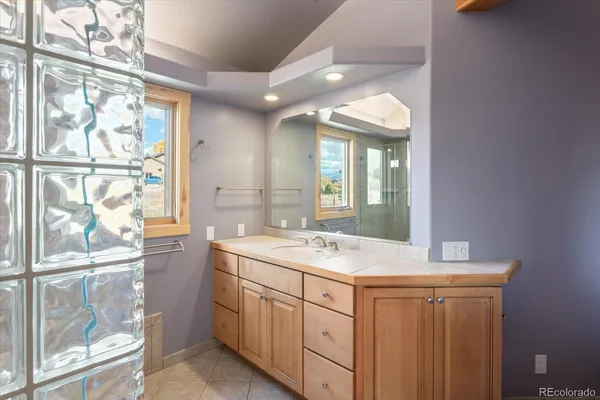 a bathroom with a sink a mirror and a shower